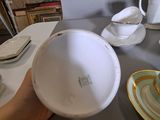 a person that is holding a bowl on a table