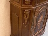 a wooden cabinet with a door on the side of it