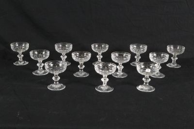 twelve glass goblets and cups on a black background