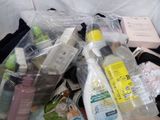 a pile of toiletries that are sitting on a bed
