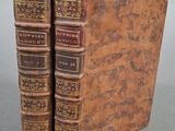 deux vieux livres posés l'un sur l'autre sur une table