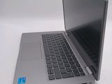 a laptop that is open on a white surface