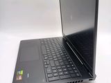 a laptop with a black keyboard sitting on a white surface