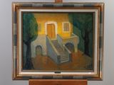 a painting on a easel with a painting of a house in the background