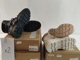 two pairs of shoes are sitting on top of boxes on a white surface