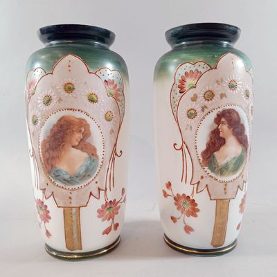two vases that have pictures of a woman on them