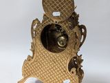 a gold clock that is sitting on a white surface