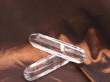 a pair of clear plastic scissors on a brown cloth