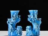 two blue vases sitting next to each other on a table
