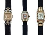 three different types of watches are displayed on a black strap