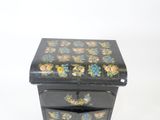 a small black box with a floral design on it