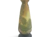 a vase that is sitting on a stand on a white surface