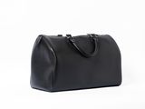 a black leather handbag on a white background