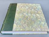 a close up of a book with a green cover on a table