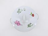 a bowl with a lid that has a bunch of vegetables on it