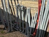 a pile of baseball bats sitting next to a brick wall