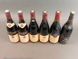 several bottles of wine are lined up on a table