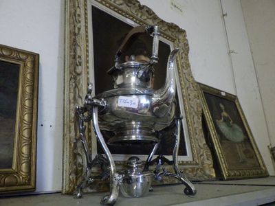 a silver tea pot sitting on top of a shelf next to pictures