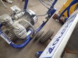 a machine that is sitting on the ground next to a truck