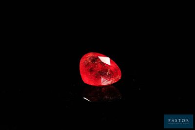 a red diamond on a black surface