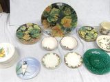 many plates and bowls on a table with a white table cloth