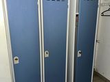 three blue lockers in a room with a tiled floor