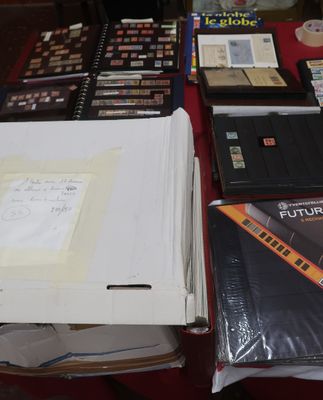 a lot of books on a table with a red table cloth