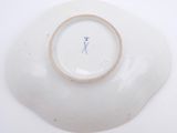 a white plate with a blue cross on it