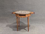 a small table with a marble top on a grey background