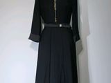 une robe noire sur un mannequin sur fond blanc