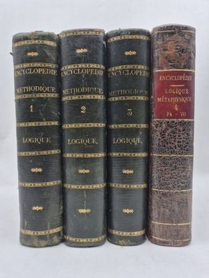 three old books sitting on top of each other on a white surface