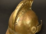 an antique brass helmet on a black background with a black background