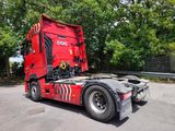 a red semi truck parked on the side of the road