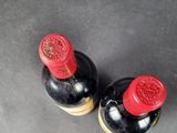 two bottles of wine that are sitting on a table