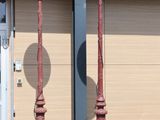 two street lamps on the side of a building