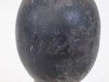 a black ball sitting on top of a wooden stand