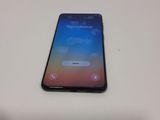 the back of a black iphone x sitting on top of a white table