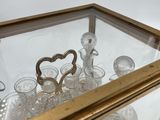 a glass display case with a lot of glasses inside of it