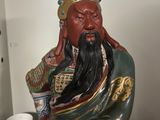 a statue of a man with a long beard holding a stick