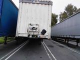 two semi trucks that are driving down the road