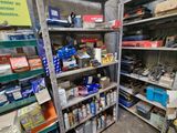 many shelves with various items on them in a room