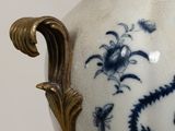 a blue and white vase sitting on a table