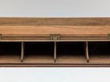 an old wooden desk with three compartments and a drawer underneath