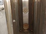 a metal elevator with a door open in a building
