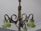 a chandelier with three flowers hanging from it ' s ceiling