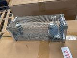 a metal cage that is sitting on top of a cardboard box