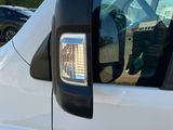 a white van parked in a parking lot next to a building