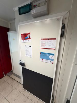 a white refrigerator in a room with a red door