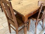 a wooden table and chairs in the kitchen