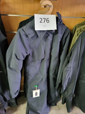 a lot of coats hanging on a rack in a store